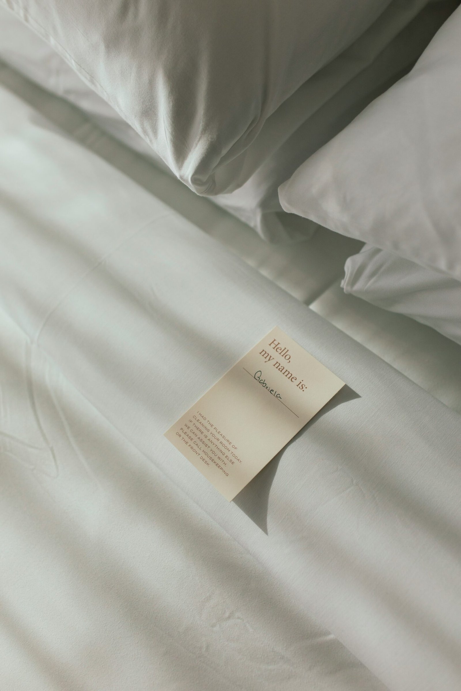 a sheet of paper on a bed with white sheets